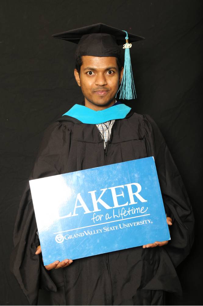 graduate student with laker for a lifetime sign